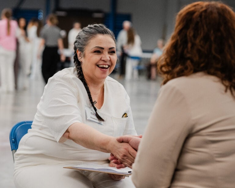 An EWOP participant shaking hands during a job readiness session