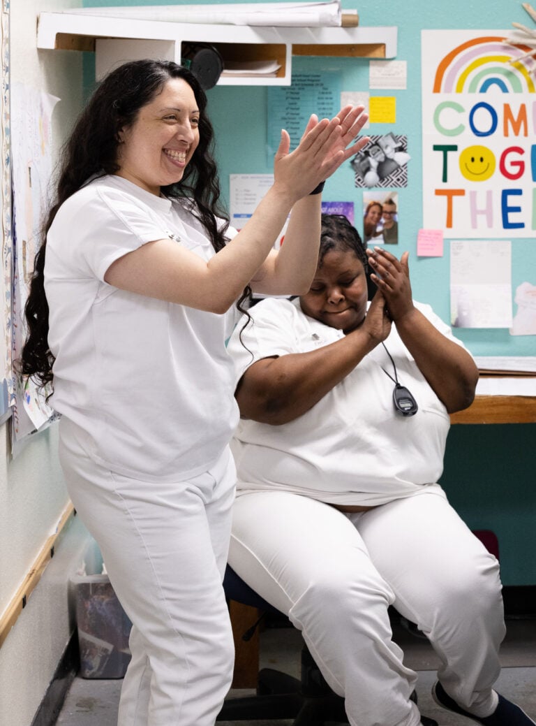 Two EWOP participants celebrating together in the program classroom