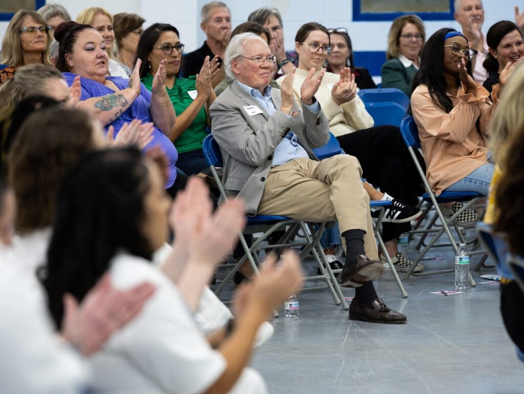 A crowd applauding at an EWOP program event